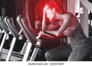 Young woman suffering from painful headache during her fitness workout in modern gym - Shutterstock ID 2145572457