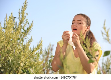 Young Woman Suffering From Ragweed Allergy Outdoors