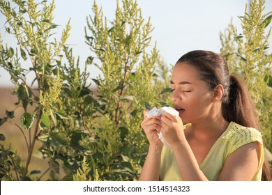 Young Woman Suffering From Ragweed Allergy Outdoors