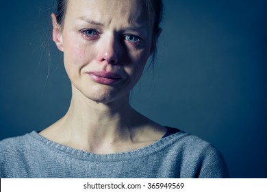 Young woman suffering from severe depression/anxiety/sadness, crying, tears coming from her eyes 