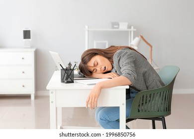 Young Woman Suffering From Sleep Deprivation In Office