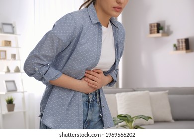 Young Woman Suffering From Stomach Ache At Home, Closeup. Food Poisoning