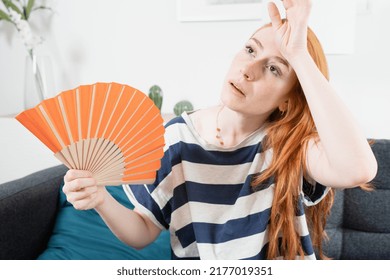 Young Woman Suffering Summer Heat Wave At Home