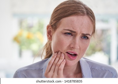 Young Woman Suffering With Toothache Touching Jaw    