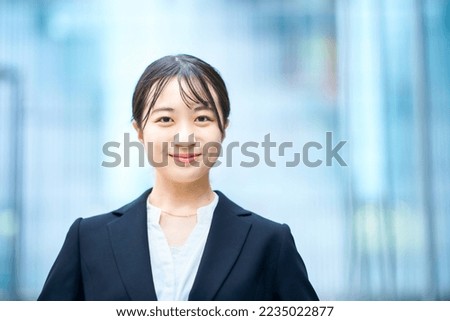 young woman in suit outdoors