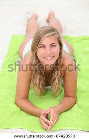 Young woman sunbathing at the beach
