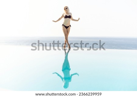 Young woman sunbathing near swimming pool.