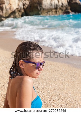 Young woman in sunglasses at beach 