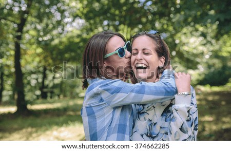 Similar – Happy women embracing and laughing over nature background