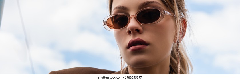 Young Woman In Sunglasses Posing Against Blue Sky, Banner