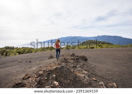 Young woman and sunset in Llano Del Jable, La Palma, Canary Islands, Spain.