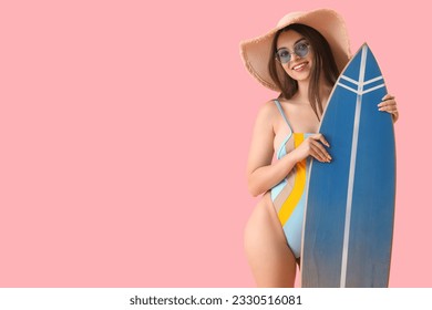 Young woman with surfboard on pink background - Powered by Shutterstock