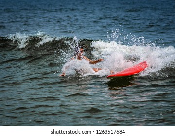 Young Woman Surfing Wipeout  