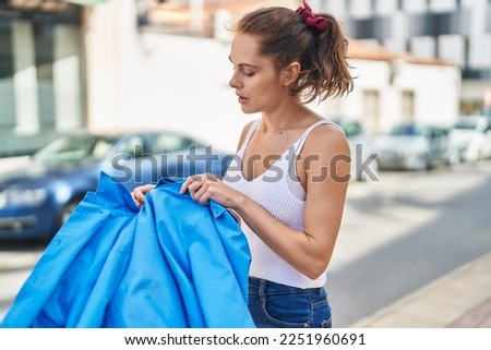 Young woman sweating standing at street