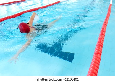 Young Woman Swim On Indoor Pool. Freestyle Mode.