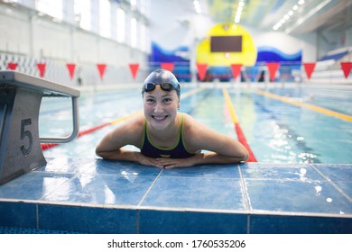 Young woman swimmer swims in swimming pool. - Powered by Shutterstock