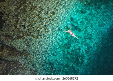 Young Woman Swimming In Beautiful Azure Sea