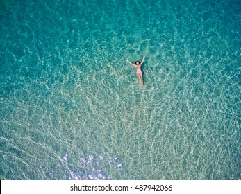 Young Woman Swimming In The Blue Sea. Top View. White Beach, Phuket, Thailand.