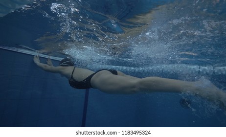 Young Woman Swimming Breaststroke In Swimming Pool Underwater View