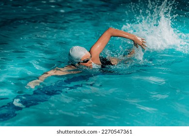 Young Woman Swimming in the Indoor Pool. - Powered by Shutterstock