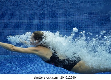 Young Woman Swimming In A Pool