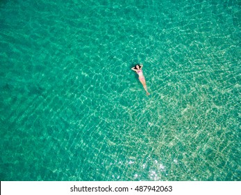 Young Woman Swimming In The Turquoise Sea. Top View. White Beach, Phuket, Thailand.