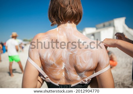 Similar – Anonymous woman applying sunscreen by the poolside