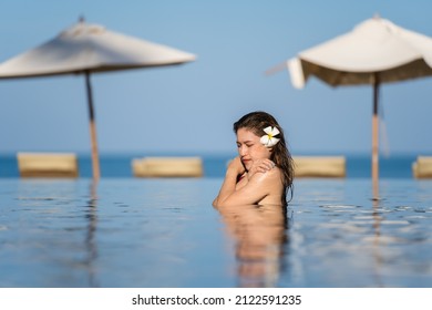 Young Woman In Swimsuit Is Swimming In A Cold Plunge Pool