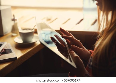 Young woman with tablet computer in cafe, close up view