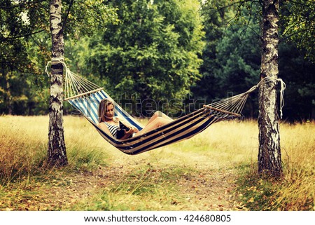 Similar – Foto Bild Young woman relaxing in a hammok