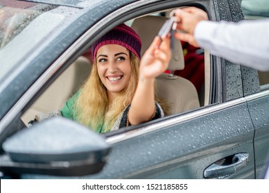 Young Woman Take The Key From Valet To Drive Her Car