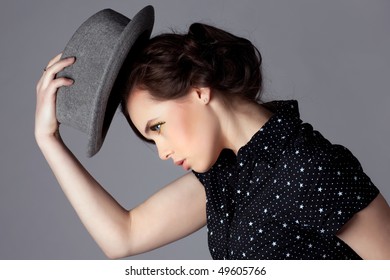 Young Woman Take Off Her Hat And Bow, Side View.