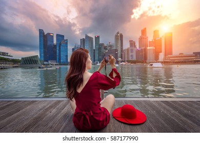 Young woman take a photos in Singapore.