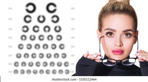 Young Woman Takes Off Glasses And Eye Chart Become Blurred. Ophthalmologist Consultation.