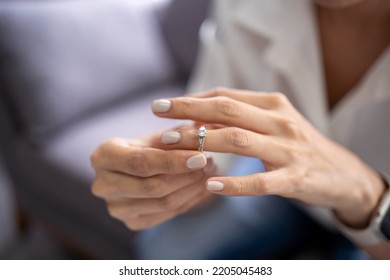 Young Woman Takes Off Wedding Ring As Sign Of Divorcement, Breakup, Cheating Wife, Infidelity, Marriage End. Relations Split Concept.