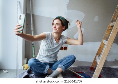Young woman takes a selfie and wants to renovate her apartment - Shutterstock ID 2165641709