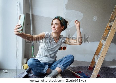 Young woman takes a selfie and wants to renovate her apartment