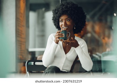 Young woman taking break and drinking coffee in cafe - Powered by Shutterstock