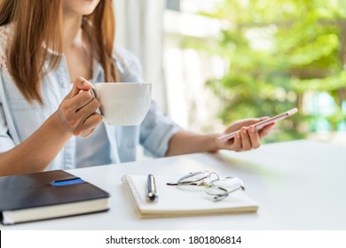 Young Woman Taking A Coffee Break And Relaxing At Living Room While Working At Home, Work From Home Concept