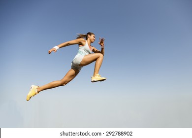 Young Woman Taking Long Jump