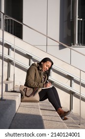 Young Woman Taking Notes Outside Work Offices