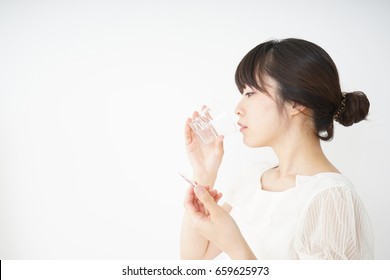 Young Woman Taking Oral Medicine