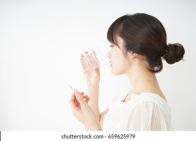 Young Woman Taking Oral Medicine