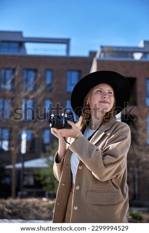 Young woman with taking photo in the city