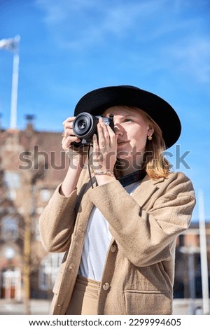 Young woman with taking photo in the city
