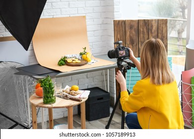 Young Woman Taking Picture Of Lemons, Mint And Ginger In Professional Studio. Food Photography