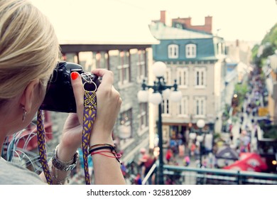 Young Woman Taking Pictures On The Busy Rue  Petit Champlain In Quebec City, Canada. North American, Adventure, Travel Vacation, Photography, Outdoors And Life Style Concept