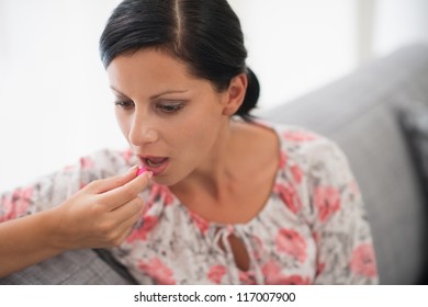 Young Woman Taking Pill