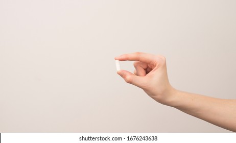 Young woman taking pill or drug, health and medicine concepts