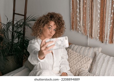 Young Woman Taking Self Shot On Smartphone